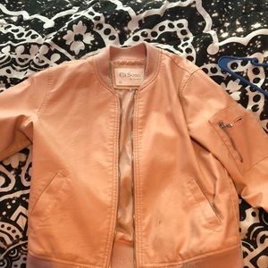 A cream bomber jacket